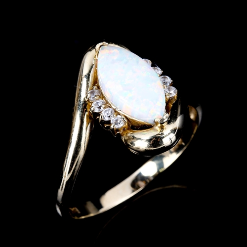 449 - A modern 14ct gold synthetic opal and cubic zirconia crossover ring, set with marquise cabochon synt... 