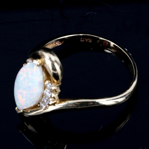 449 - A modern 14ct gold synthetic opal and cubic zirconia crossover ring, set with marquise cabochon synt... 