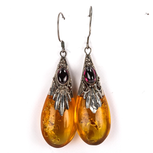 453 - A pair of Continental amber pendant earrings, unmarked silver settings with cabochon garnet and shep... 