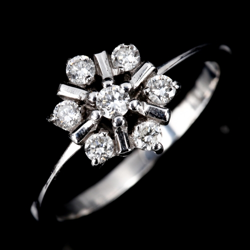 467 - A modern diamond cluster snowflake dress ring, unmarked white gold settings test as 18ct, set with m... 