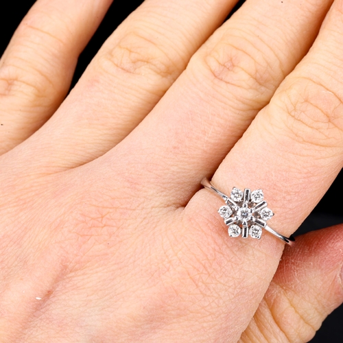 467 - A modern diamond cluster snowflake dress ring, unmarked white gold settings test as 18ct, set with m... 