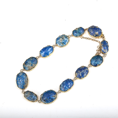 504 - A sodalite line bracelet, unmarked gold settings test as 18ct, bracelet length 18cm, 13.5g