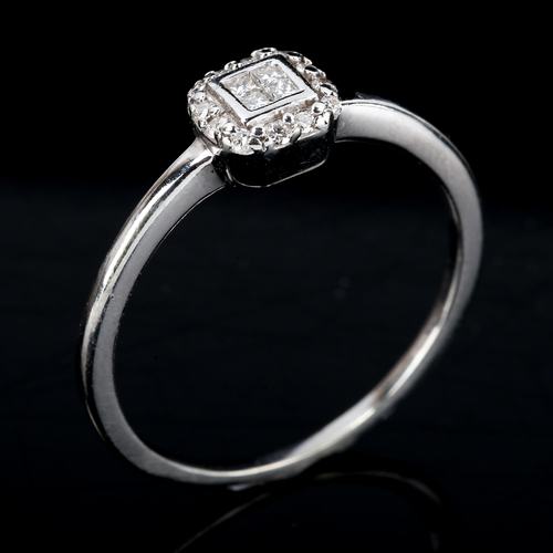 538 - A modern diamond cluster ring, unmarked settings test as 9ct white gold, set with Princess and moder... 