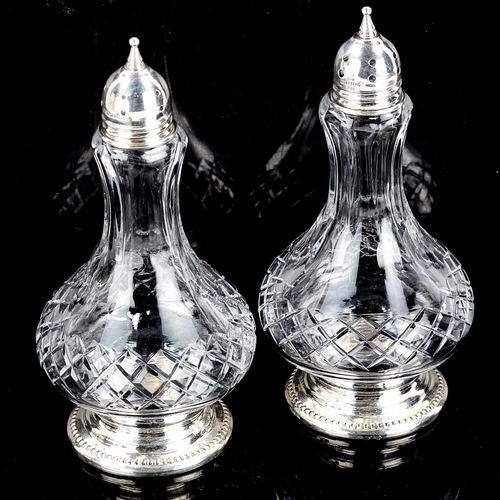 554 - A pair of sterling silver-mounted glass pepperettes, baluster form, height 12cm