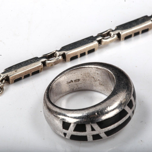 566 - A Continental sterling silver and black enamel bombe ring, size M, and a similar panel bracelet, len... 