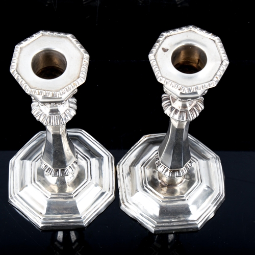 568 - A pair of late Victorian silver table candlesticks, by George Unite, hallmarks Birmingham 1899, heig... 