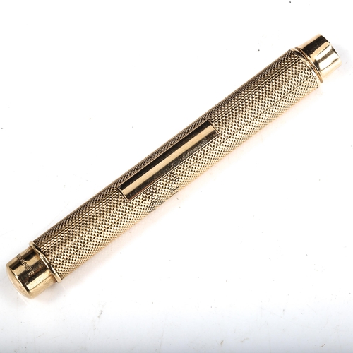 592 - SAMPSON MORDAN & CO - an early/mid-20th century 9ct gold propelling pencil, engine turned decoration... 