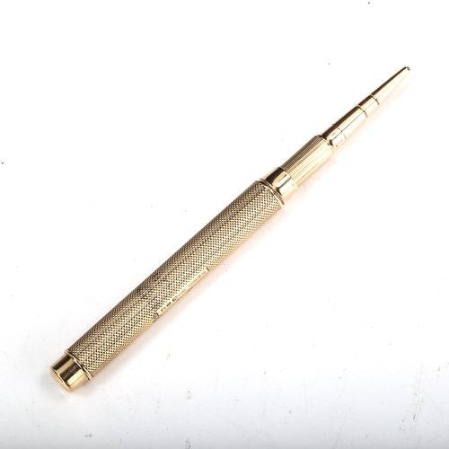 592 - SAMPSON MORDAN & CO - an early/mid-20th century 9ct gold propelling pencil, engine turned decoration... 