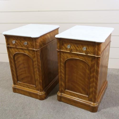 1263 - A pair of 19th century satinwood pedestal cupboards, with shaped white marble tops, single frieze dr... 