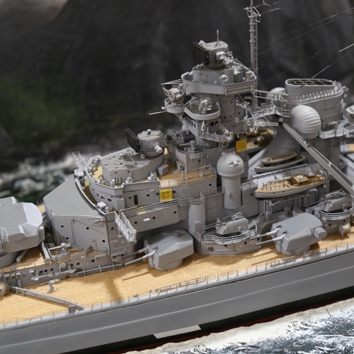 1287 - A large scale model of The Bismarck, in floor standing glazed wooden display case, 144cm