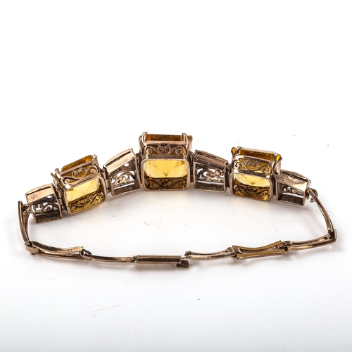 242 - A late 20th century stone set bracelet, unmarked rose gold settings with paste stones and pierced sc... 