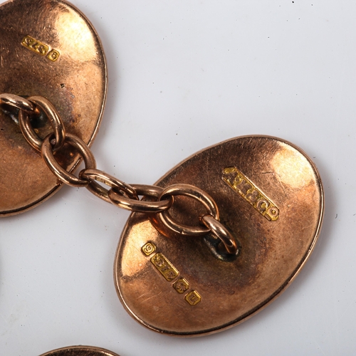 261 - A pair of early 20th century 9ct rose gold oval panel cufflinks, engraved foliate decoration, hallma... 