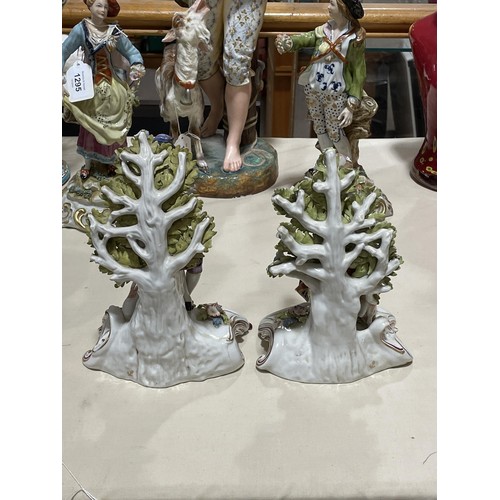 1297 - A pair of porcelain musician figures, with gold anchor marks, height 22cm