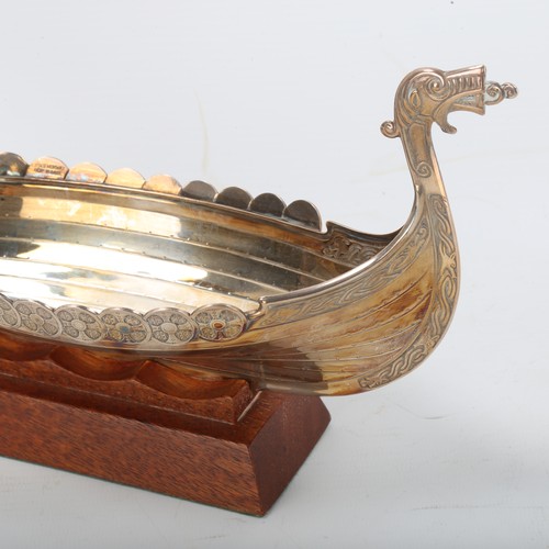 1292 - A Scandinavian electroplate table centre bowl, in the form of a Viking longboat, on hardwood stand, ... 