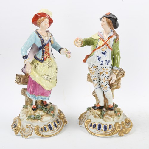 1295 - A pair of porcelain romantic figures, red anchor marks, height 29cm