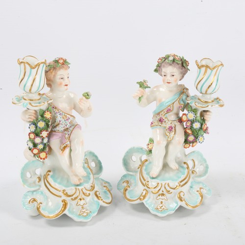 1296 - A pair of 19th century porcelain candlesticks, supported by putti figures, gold anchor marks, height... 