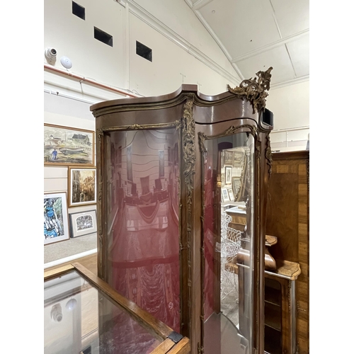 1288 - A French walnut and ormolu-mounted vitrine cabinet, with serpentine glass panels, and printed romant... 