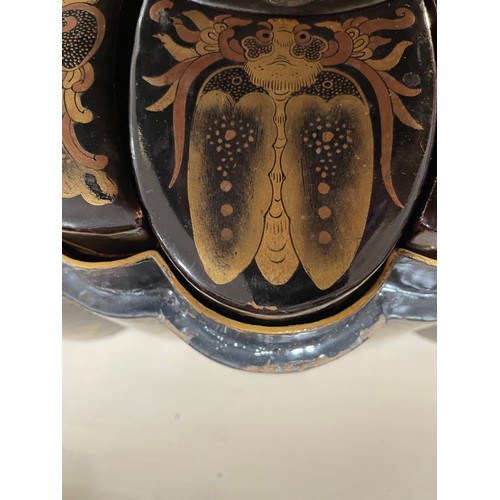 1052 - An unusual Chinese gilded and lacquered box in the form of a butterfly, the interior fitted with nes... 