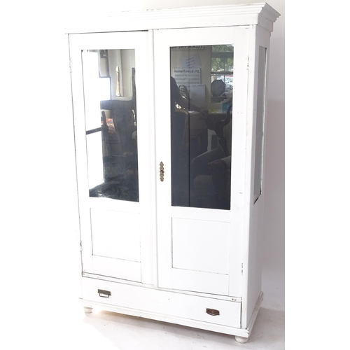 2072 - A white painted pine display cabinet with 2 fixed shelves, glazed panelled doors and sides, and sing... 