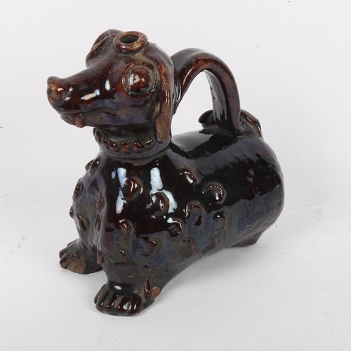 131 - An 18th/19th century treacle glaze pottery figural Dachshund dog jug, height 18cm