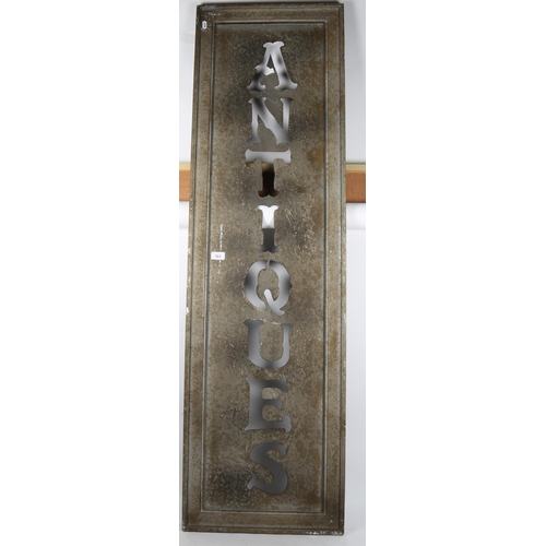 163 - An acid washed aluminium Antiques stencil shop sign, framed, overall 150cm x 44cm