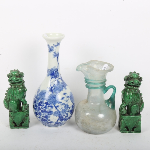 198 - A Japanese blue and white porcelain bottle vase, a pair of Chinese green glaze Dogs of Fo, and a Rom... 