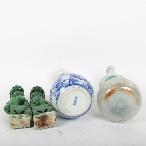 198 - A Japanese blue and white porcelain bottle vase, a pair of Chinese green glaze Dogs of Fo, and a Rom... 