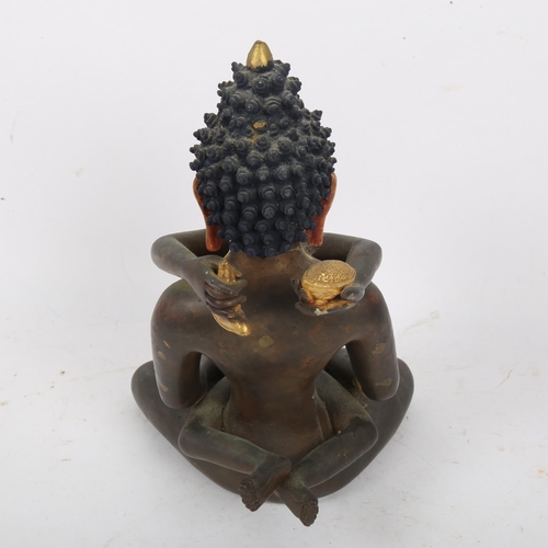 212 - A Chinese hand painted and gilded patinated bronze seated Buddha figure, height 23cm