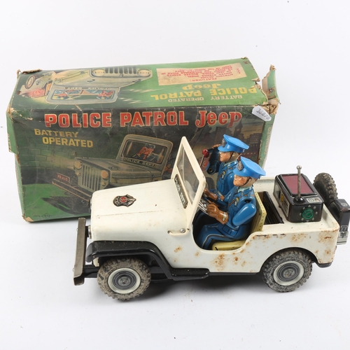 98 - NOMURA TN - a Vintage Japanese battery operated tinplate Police Patrol Jeep toy, boxed