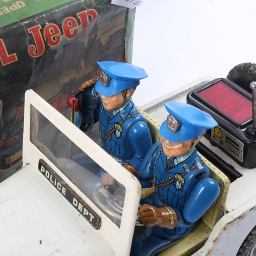 98 - NOMURA TN - a Vintage Japanese battery operated tinplate Police Patrol Jeep toy, boxed