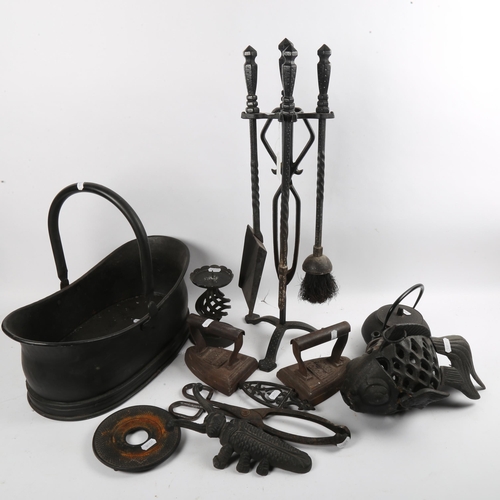 255 - A group of wrought-iron fireside tools, flat irons etc