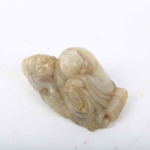 275 - A Chinese carved and polished jade figure, sleeping sage with bead necklace and tiger, length 8.5cm