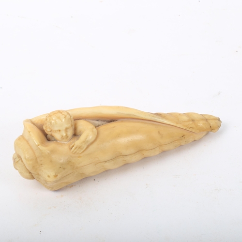 286 - A 19th century carved ivory conch and putti walking stick handle, length 11cm