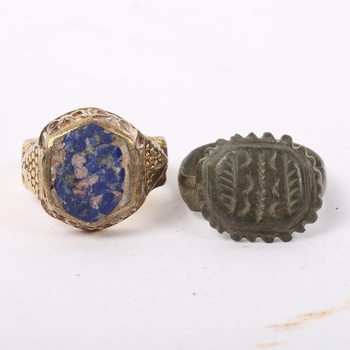 294 - A Medieval bronze seal ring, and an unmarked yellow metal seal ring with lapis panel (2)