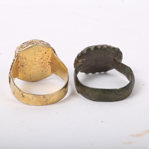 294 - A Medieval bronze seal ring, and an unmarked yellow metal seal ring with lapis panel (2)