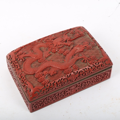 300 - A Chinese red cinnabar 'dragon' box, 15cm x 10cm