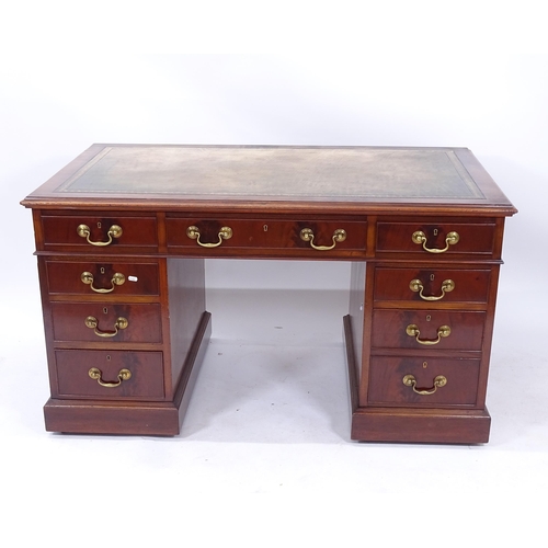 2016 - An early 20th century mahogany twin-pedestal writing desk, with an inset tooled green leather skiver... 