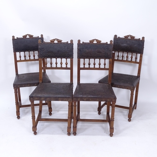 2018 - A set of 4 early 20th century dining chairs, with tooled leather panelled backs and seats, on fluted... 