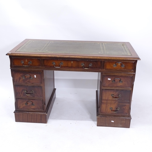 2025 - A reproduction mahogany twin-pedestal writing desk, W124cm, H77cm, D62cm, kneehole height 60cm and w... 