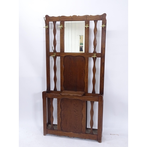 2040 - A 1920s panelled oak mirror-back hallstand, W93cm, H188cm