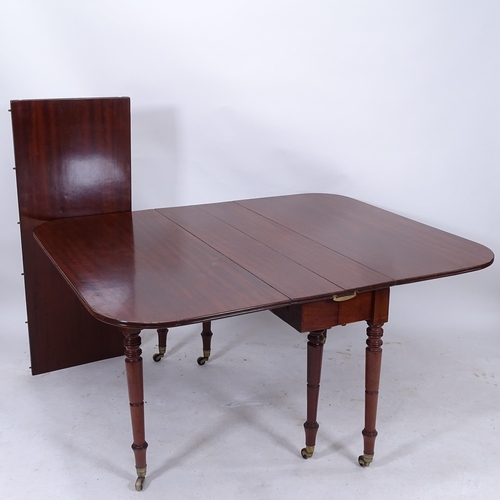 2069 - WITHDRAWN - A Georgian mahogany drop leaf extending dining table, with reeded edge, raised on 6 ring... 