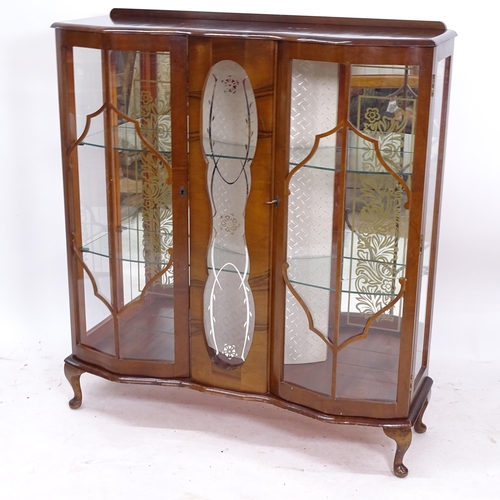 2089 - A 1930s walnut serpentine-front glass display cabinet, with 2 glazed doors, W105cm, H116cm, D35cm