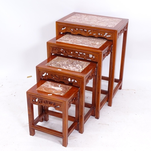 2092 - An Oriental rectangular marble-top nest of 4 occasional tables, with carved pierced frieze, widest 5... 