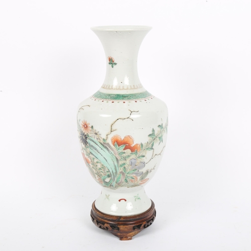 359 - A Chinese famille verte porcelain baluster vase, hand painted floral decoration, height 24cm, on har... 