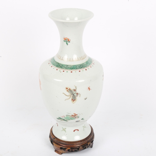 359 - A Chinese famille verte porcelain baluster vase, hand painted floral decoration, height 24cm, on har... 