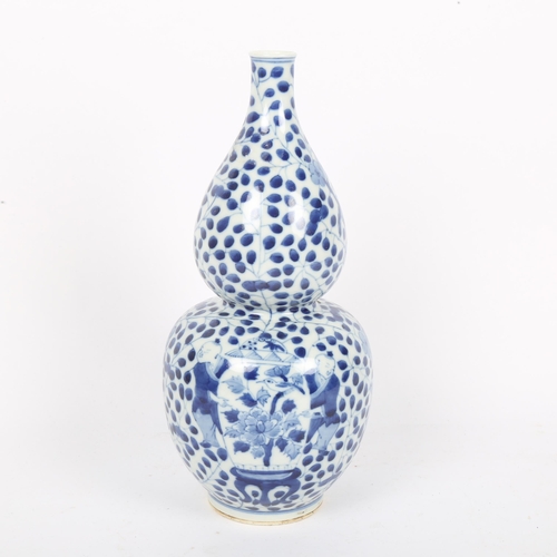 363 - A Chinese blue and white double-gourd vase, figural and floral decoration with jars, height 29cm