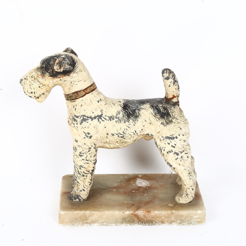 440 - A painted spelter Schnauzer dog sculpture, on onyx base, length 19cm (tail A/F)