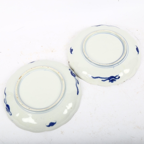 554 - A pair of Chinese hand painted and enamelled porcelain carp plates, diameter 21cm