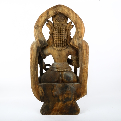 688 - A carved wood deity, height 70cm