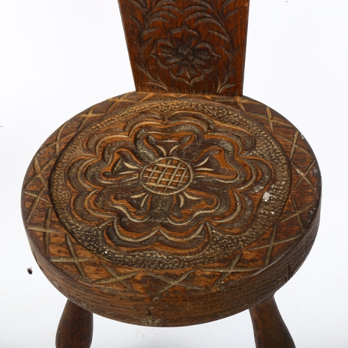 711 - A carved wood miniature chair with floral design, height 53cm